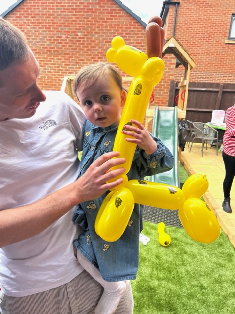 girl holding a giraffe balloon in telford